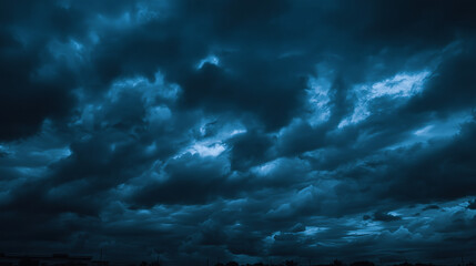 Dramatic dark storm clouds gathering before heavy rain in the evening sky