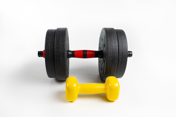 Black and yellow dumbbells on a white background. Sports equipment. Dumbbells top view
