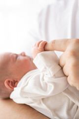 A happy father holds his newborn son. Concept of time spent with father and child.