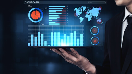 A business professional showcases a modern data visualization on a tablet, featuring graphs and a world map, set against a sleek dark background. Impute