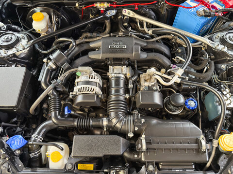 Bangkok, Thailand - August 9, 2025: Toyota D-4S Boxer engine under the hood of Subaru sports car at used car dealership showroom