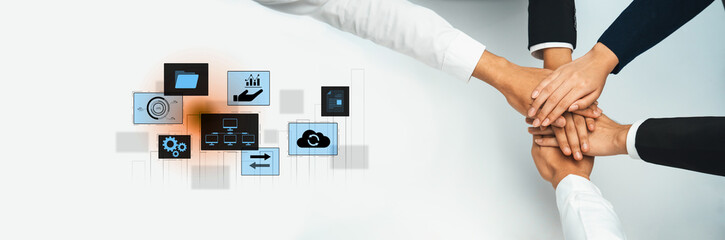 Diverse hands stacked together illustrate unity and teamwork in a digital setting, emphasizing...