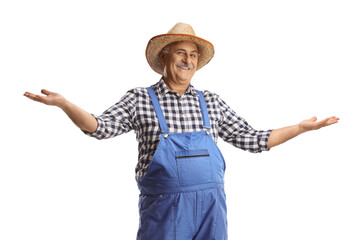 Mature farmer in blue overalls gesturing welcome
