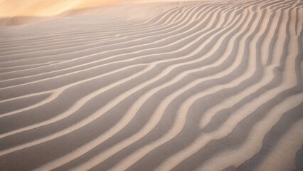 Fototapeta premium Sand dune pattern in the desert with wind blowing sand, creating a beautiful landscape