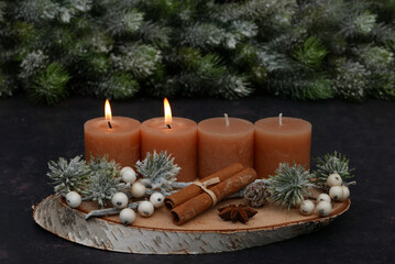 Second Advent: Natural Advent decorations with fir branches, cinnamon sticks, and brown candles.