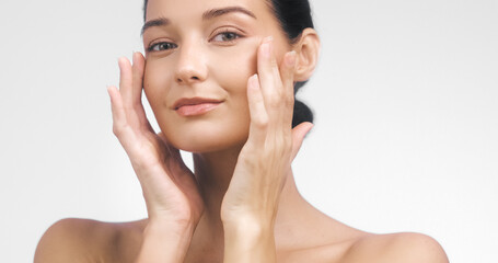 Beauty Concept with Woman Massaging Cheeks and Radiant Natural Skin