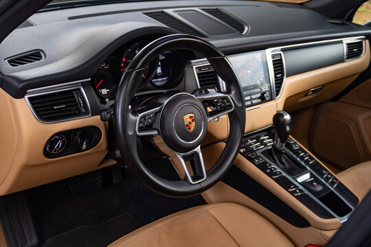 Porsche Macan cockpit with tan leather interior, luxury SUV driver perspective