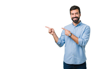 Cheerful young man pointing sideways at empty space