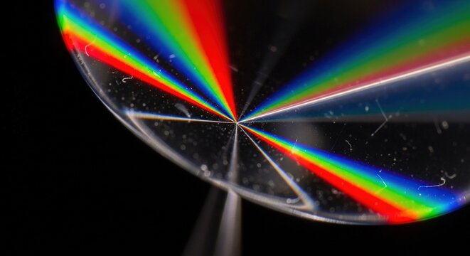 Stunning spectral rainbow light refraction through crystal prism creating vibrant spectrum for science education or abstract backgrounds