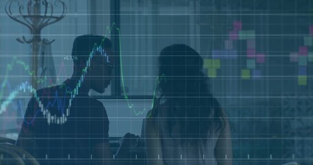 Man typing laptop sparking finance chart overlay as woman arriving holding tablet analyzing data - Powered by Adobe