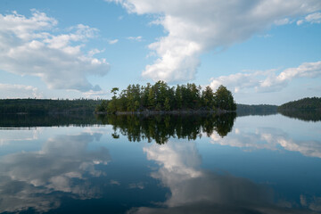 Dramatic Clouds Reflecting on Calm Wilderness Lake
