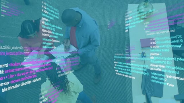 Colleagues opening code folder and pointing highlights by exchanging sheets near laptop for review