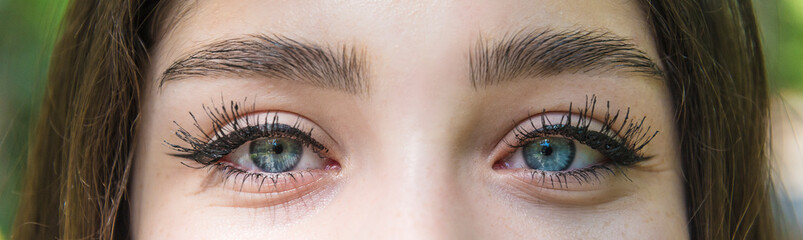 Beautiful girl's made-up eyes looking to camera