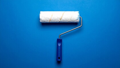 Obraz premium Clean white paint roller with a blue handle on a solid blue background.