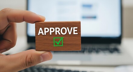 Hand holding wooden block with approve text and green checkmark image