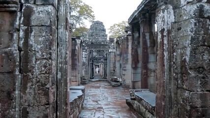 Atmospheric corridors of Banteay Kdei Temple with ornate carved stone walls and columns. Angkor Wat, Cambodia. Shot in motion