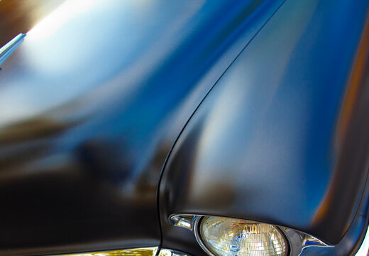 Close-up of a Black Car Hood and Fender 
