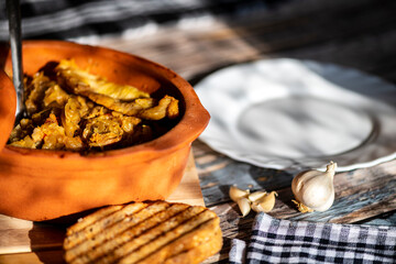 A bowl of cooked cabbage served in a rustic brown dish, showcasing its soft texture and warm, comforting appearance. The natural colors and simple presentation make this image suitable for traditional