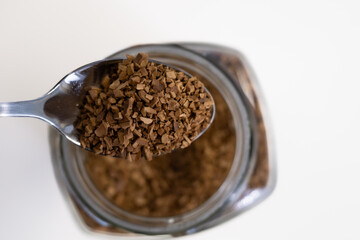 Close-up of instant coffee on a spoon ready to be mixed