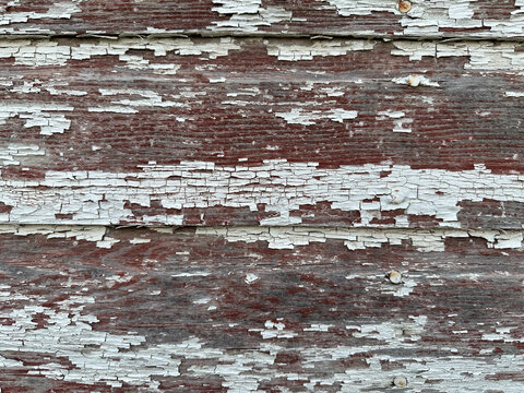 Close-Up of Wood Siding on Old Barn with Peeling Red and White Paint