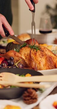 Chicken, hands of person in house with cutting, preparation or celebration buffet in Christmas roast. Thanksgiving, food or host at home with vegetables, festive dish or meat carving at holiday table