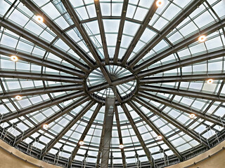 Unique glass dome with radial design offers stunning views of the sky and natural light in an urban setting