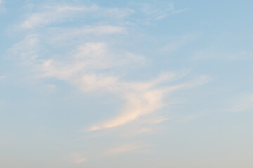 Serene light blue sky with soft white clouds