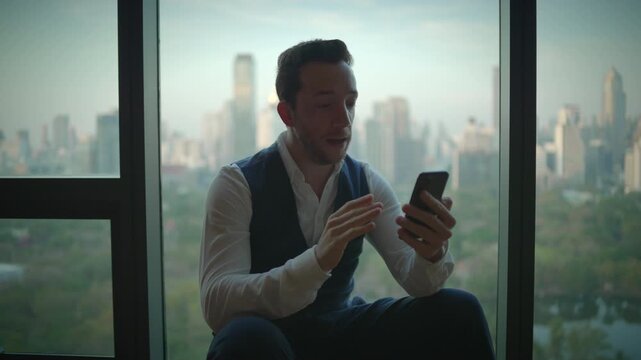 A businessman is effectively communicating through his smartphone in a modern office setting