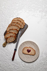 Artisan Sourdough Bread and Heart-Shaped Jam Toast on White Background