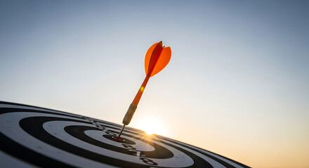Dart arrow hitting in the target center with sunlight in the background