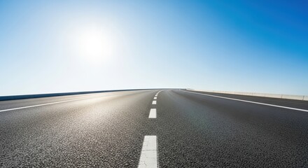 Fototapeta premium Scenic empty highway under blue sky with sunlight