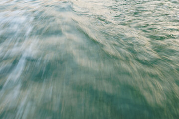 Abstract motion blur of turbulent green water surface
