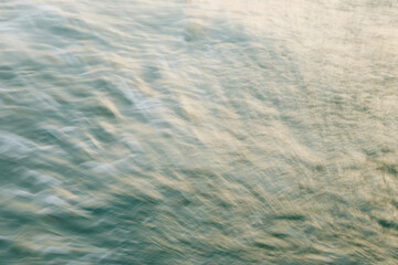 Abstract water motion with light reflections in soothing blue and beige tones