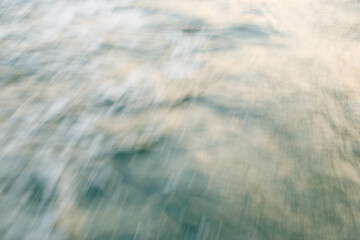 Abstract blur of ocean waves in motion on a calm day