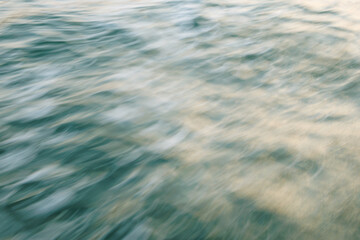 Abstract motion blur of ocean waves in soft light