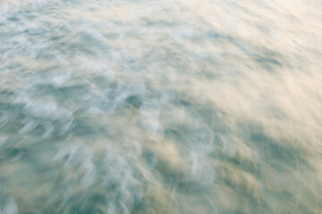 Abstract blurred water surface with soft waves and gentle ripples