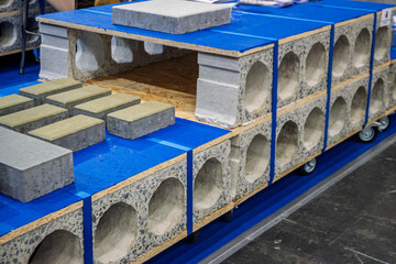 Innovative modular concrete blocks and pavers showcased at a construction exhibition, highlighting...