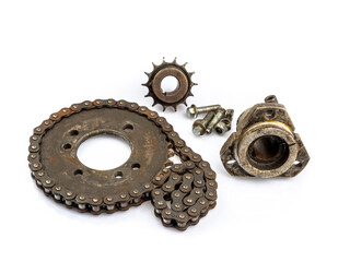 Close up of dirty, oily and greasy old motorcycle chain and sprocket set on white background. The image reflects the essence of repair, maintenance