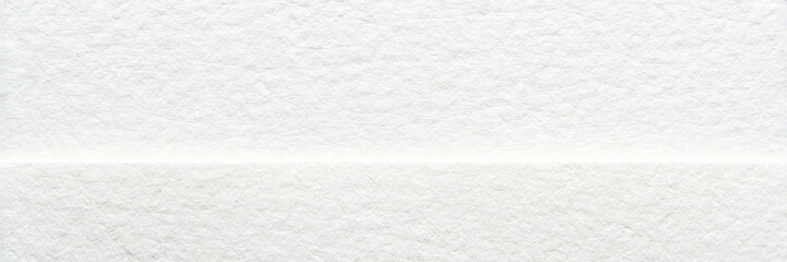 Obraz premium White textured paper background with subtle horizontal line and fibrous surface details.