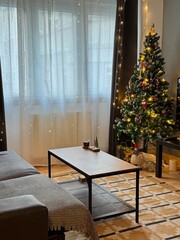 A living room decorated for the New Year, Christmas, and with a Christmas tree