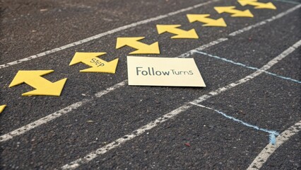 Yellow Arrows on Pavement Indicate Directions for Walking Path