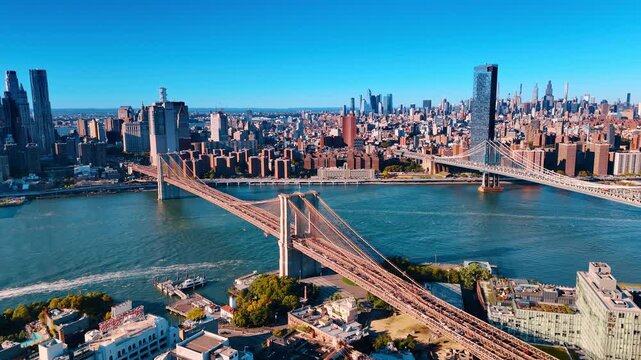 Flying over Brooklyn on sunny day. View on the Brooklyn and Manhattan bridges from drone.