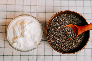Roasted chia seeds served with yogurt on a checkered tablecloth