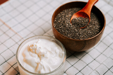Roasted chia seeds alongside creamy yogurt in a cozy kitchen setting