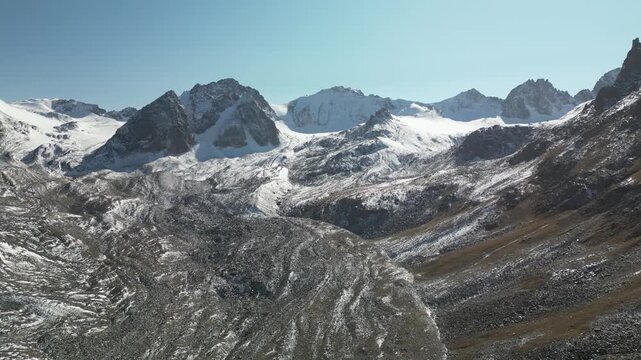 Aerial drone footage of snow-covered moraine of the Bolshoi Ala-Archa glacier, Kyrgyzstan. 