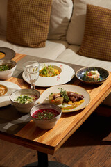 An Array of Varied and Delicious Dishes Delightfully Presented on a Wooden Table Surface