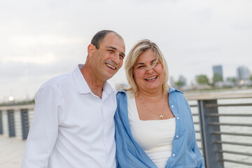 Obraz premium A woman and a man, a mature couple, are happy together. Active recreation in the park outdoors.