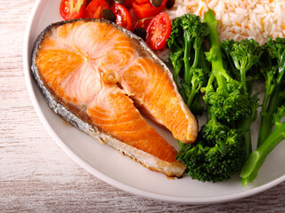Healthy plate with salmon, broccoli, salad and rice
