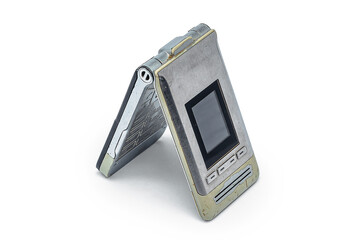 Vintage silver and beige flip phone with worn body on white