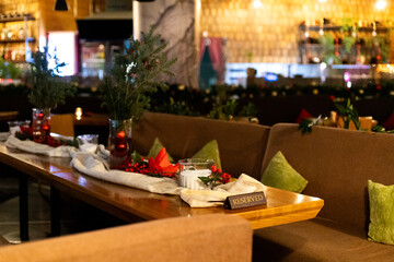 Christmas-decorated restaurant table with reserved sign and festive ornaments